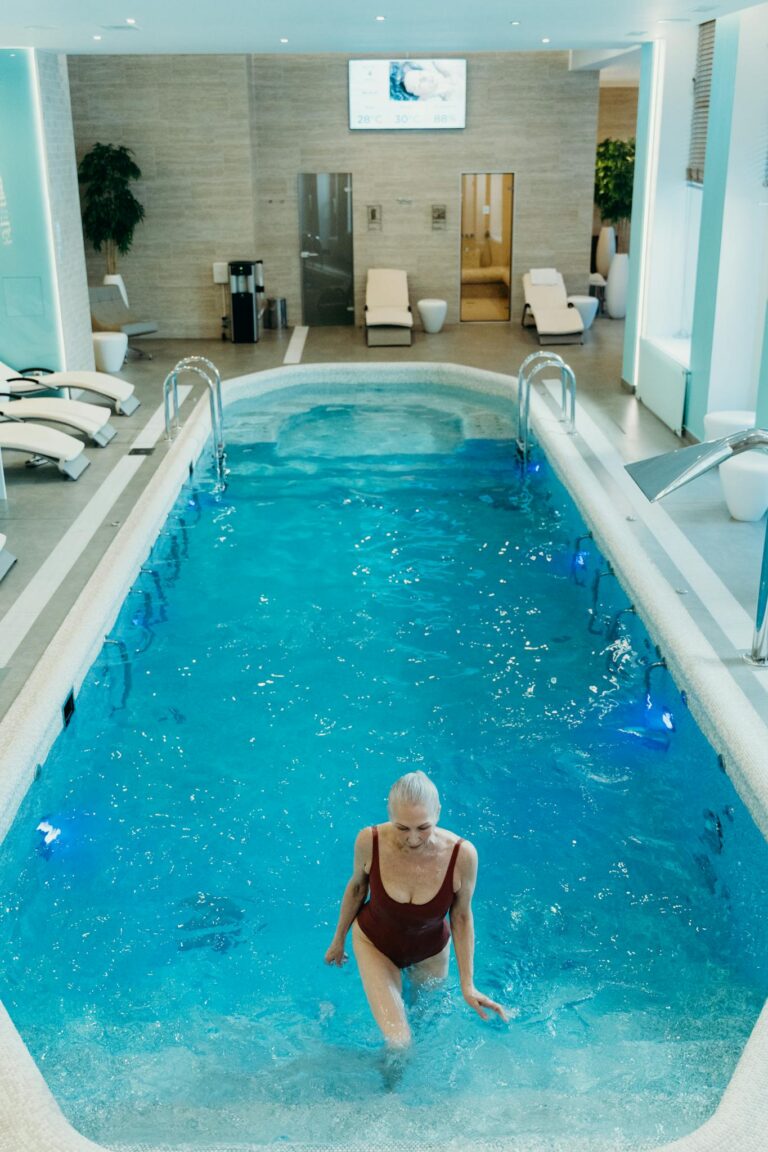 Woman stepping into an indoor pool, perfect for relaxation and leisure time.